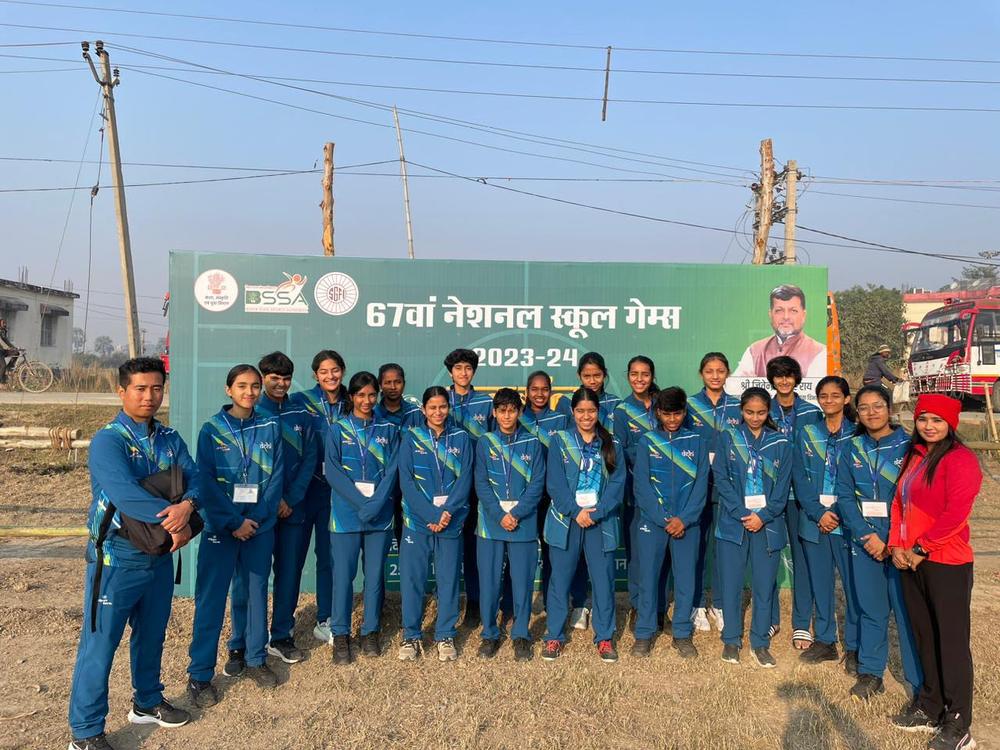 The Delhi squad in blue tracksuits in front of the 67th National School Games board in Saran, Bihar