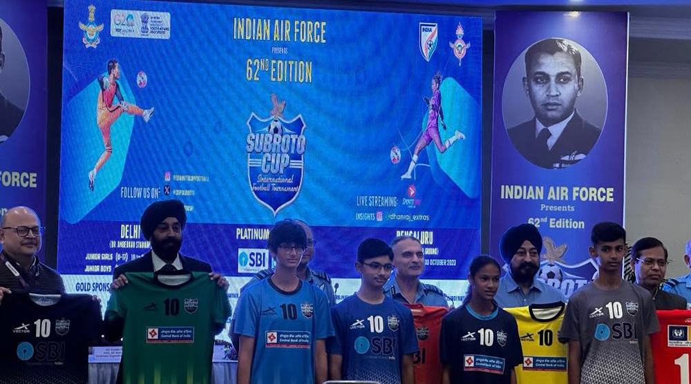 Players holding up kits at the unveiling of the official jersey for the 62nd Subroto Cup, presented by the Indian Air Force